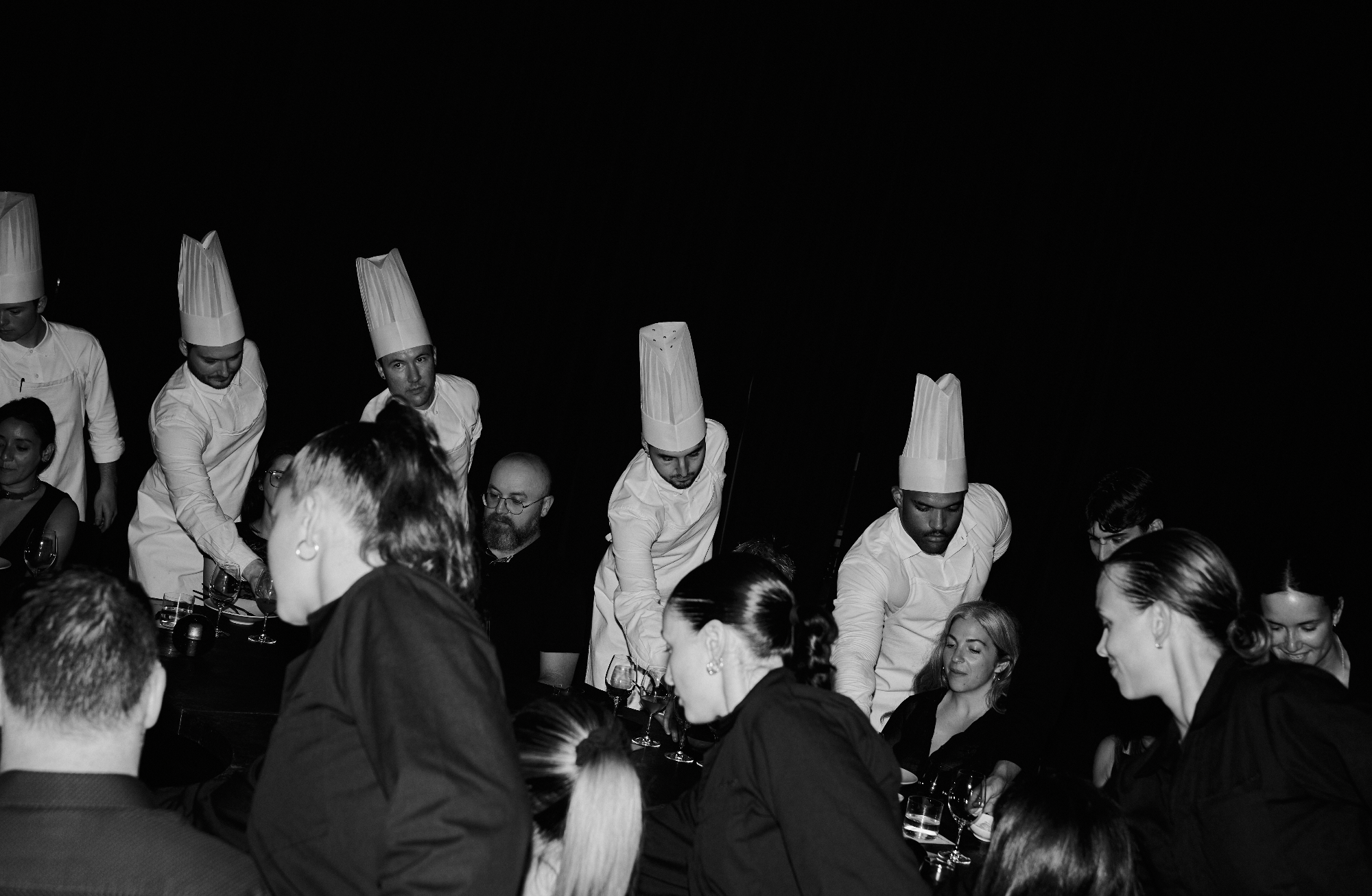Synchronized water service ritual featuring Evian natural spring water